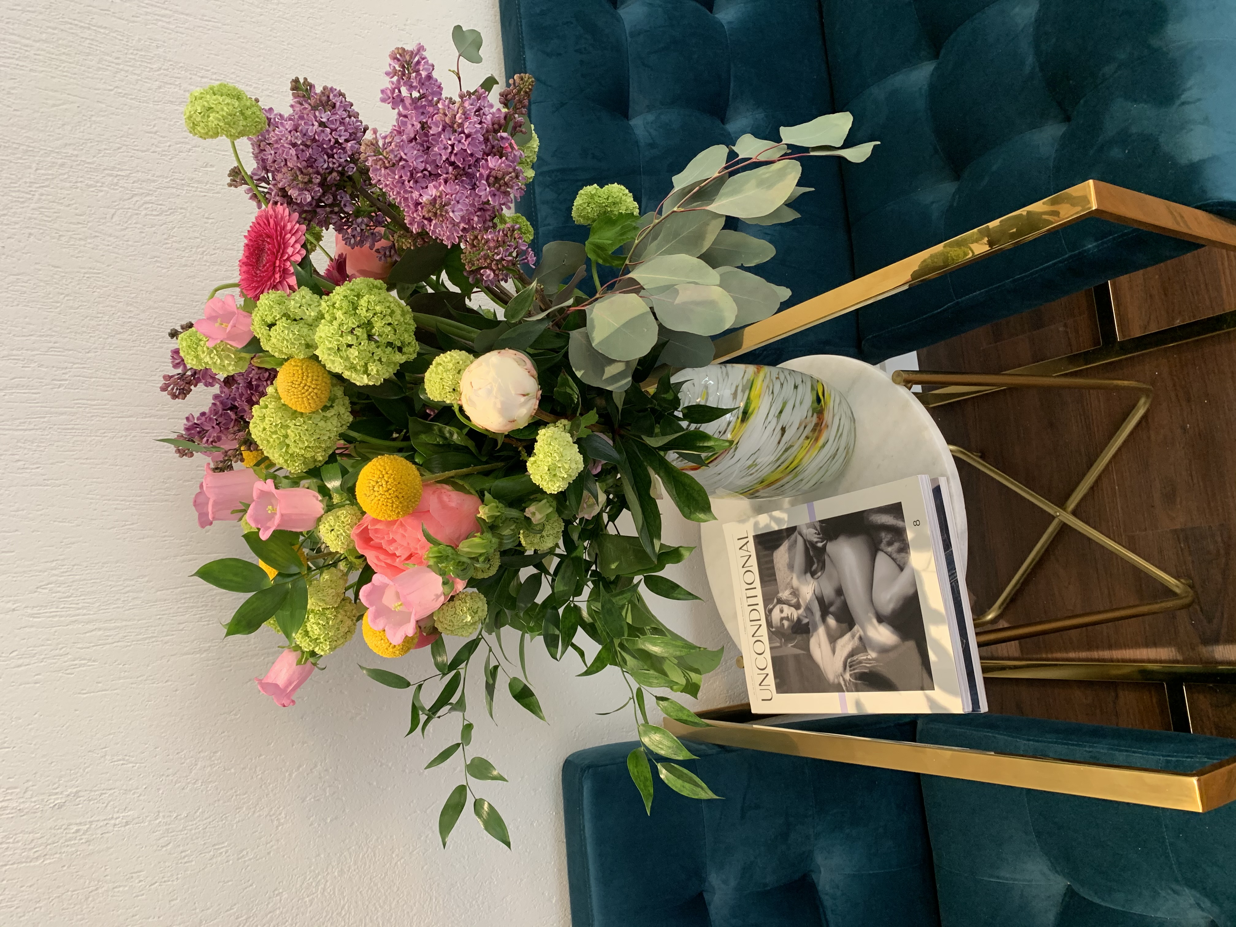 Fresh flowers on teal sofa